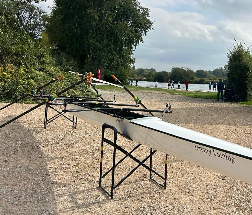 The newly renamed Jeremy Laming coxless quad on trestles beside the River Thames at Shiplake Vikings Rowing Club