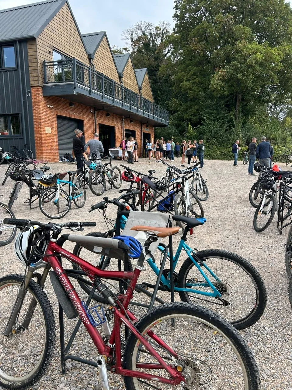 Mountain bikes and helmets lined up on the gravel outside Shiplake Vikings Rowing Club boathouse before the Jeremy Laming memorial triathlon